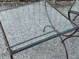 two tables that have glass tops on them on the ground