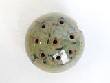 a picture of a ceramic object with holes in it