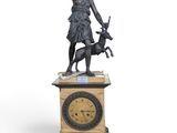 a statue of a woman with a dog and a clock