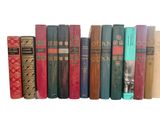 many books that are lined up on a shelf