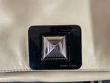 an image of a white purse with a black square in the center