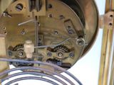 a close up of a clock with a wire attached to it