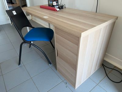 a wooden desk with a blue chair in front of it