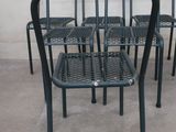 four chairs and a table on the concrete floor