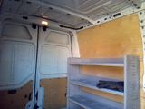 a white van with shelves in the back of it
