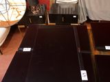 three laptops sitting on a table in a room