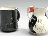 two black and white vases with designs on them