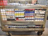 a metal cart with books on it in a store
