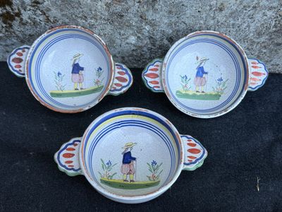 three bowls that are sitting on a black surface