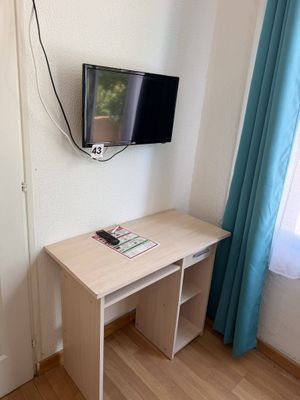 un petit bureau sur lequel est posée une télévision