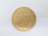 a close up of a gold coin on a white surface