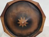 une horloge en bois ornée d'une étoile, posée sur un socle