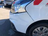 a white van with red stripes parked in a parking lot