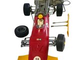 a red toy race car with a steering on a white background