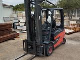 a forklift that is sitting in the middle of a lot