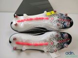 adidas soccer cleats with red and white laces on the soles