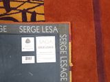 a blackboard on the floor next to a brown rug