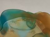 a close up of a glass vase with a blue and yellow design