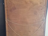 a wooden box with a chain on top of it
