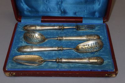 four spoons and a fork in a case