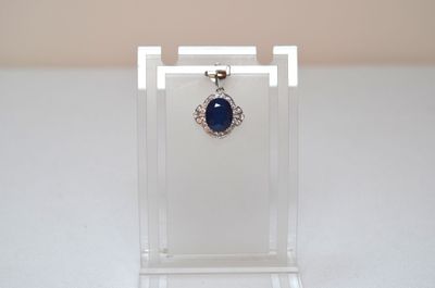 a close up of a necklace with a blue stone on it