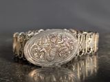 an image of a silver bracelet with an oval design on it