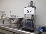 a coffee grinder sitting on a counter in a kitchen