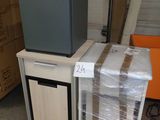 a television sitting on top of a cart in a warehouse