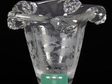 a clear glass vase with a green label on it