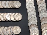 a lot of coins sitting on a table with a black background
