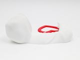a white object with a red handle on a white surface