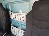 two seats in the back of a van with a cooler in the back