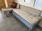 a couch and a chair in the corner of a room
