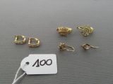 several pairs of earrings and a price tag on a table