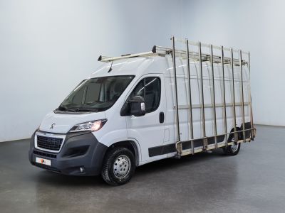 a picture of a white truck with a cage on the back of it