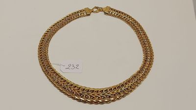 un bracelet en chaîne d'or muni d'un fermoir, posé sur un fond blanc