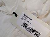 the label on the white shirt is telling the price of the item