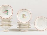 five plates with flowers on them on a white table