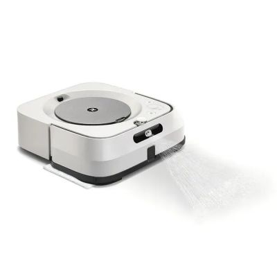 une image représentant un aspirateur robot noir et blanc posé sur une surface blanche