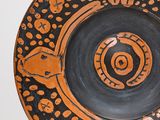 a black and orange plate with a design on it