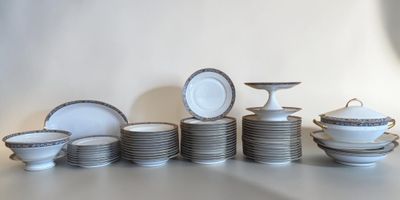 a lot of plates and bowls sitting on a table