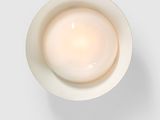 an overhead view of a bowl of yogurt on a white surface