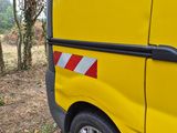 a yellow van with a red and white stripe on the side