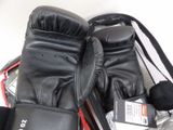 a pair of boxing gloves sitting on top of a tennis racket