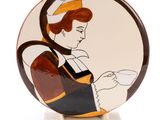 a picture of a plate with a woman holding a cup