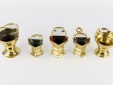 four gold vases with handles and handles on a white surface