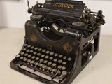 an old typewriter sitting on a table in a room