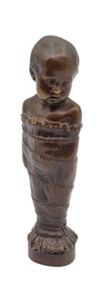 a small statue of a child on a pedestal