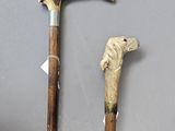 two old walking canes that are next to each other