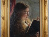 painting of a young girl reading a book in a gold frame